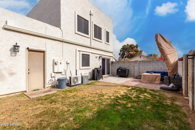 back of house with ac unit, a patio, and a lawn