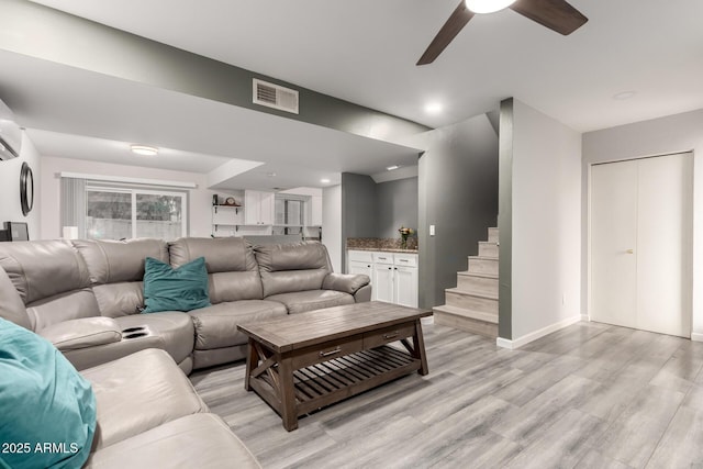 living room with ceiling fan and light hardwood / wood-style floors