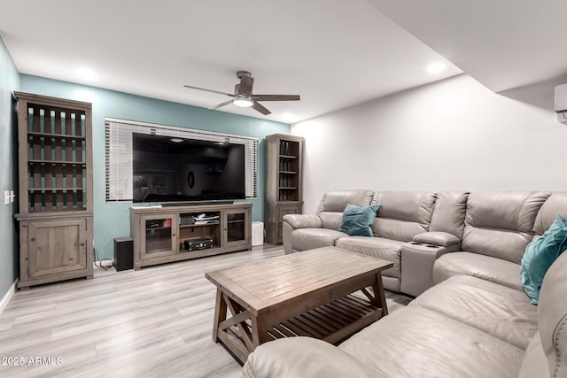 living room with ceiling fan and light hardwood / wood-style flooring