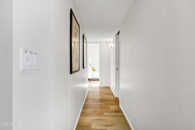 hallway with light hardwood / wood-style flooring