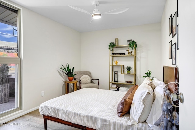 bedroom with light hardwood / wood-style floors and ceiling fan