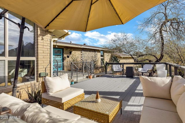 view of patio with an outdoor living space and a deck