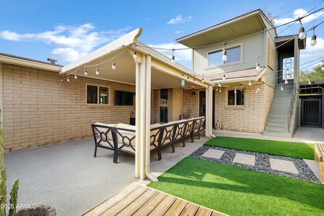 rear view of house with an outdoor hangout area, a patio area, and a lawn