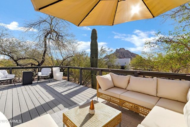 wooden terrace featuring an outdoor living space and a mountain view