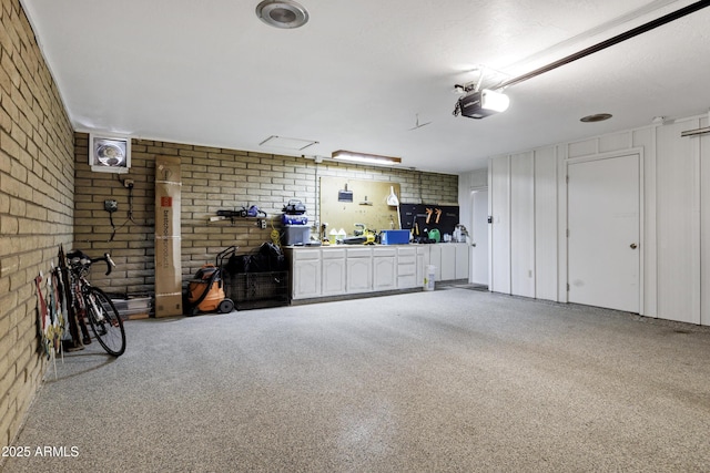 garage featuring a garage door opener and a workshop area