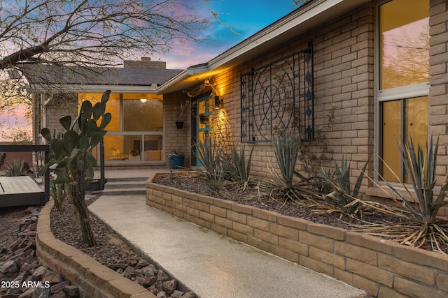 view of exterior entry at dusk