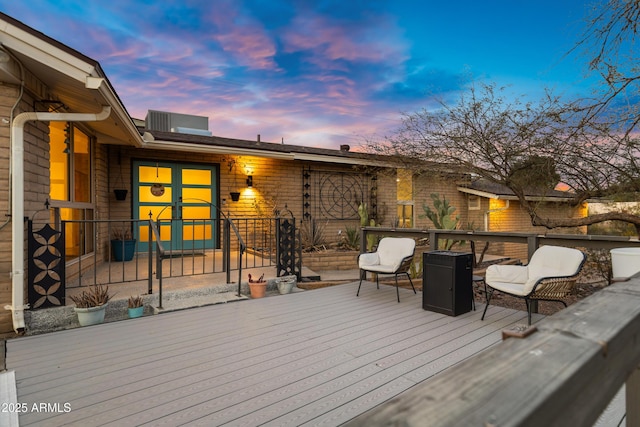 deck at dusk with outdoor lounge area