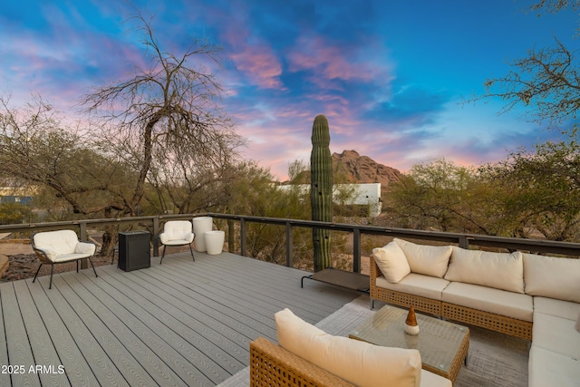 deck at dusk with an outdoor hangout area