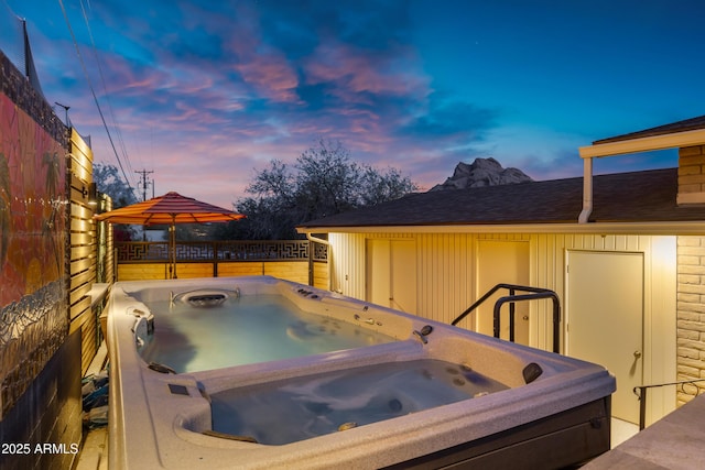 exterior space with a hot tub