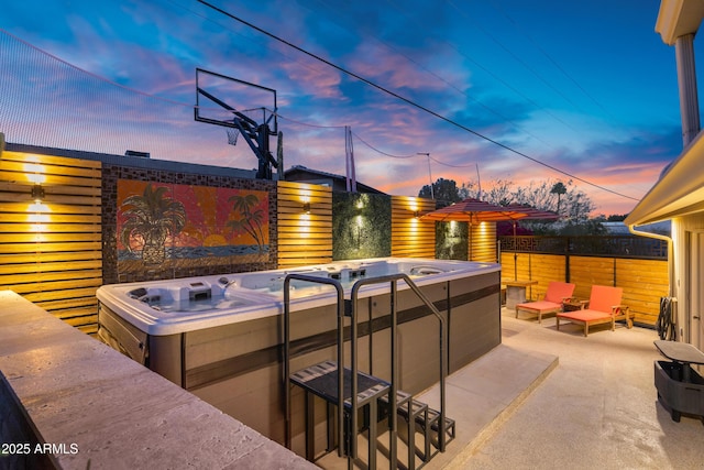 patio terrace at dusk with a hot tub