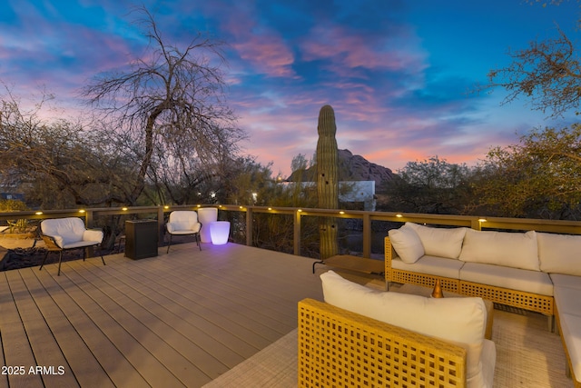 deck at dusk with an outdoor hangout area