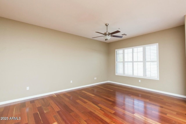 2989 N 44th St N Unit 2007, Phoenix, AZ 85018 - spare room featuring baseboards, wood finished floors, and a ceiling fan