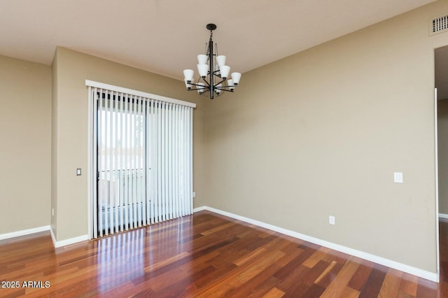 2989 N 44th St N Unit 2007, Phoenix, AZ 85018 - spare room with wood finished floors, a chandelier, and baseboards