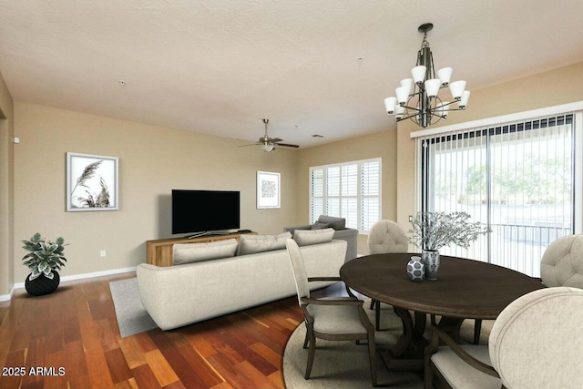 2989 N 44th St N Unit 2007, Phoenix, AZ 85018 - dining space with a chandelier, baseboards, ceiling fan, and dark wood-style flooring