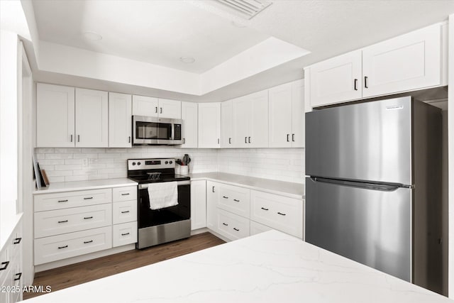 1800 W Shawnee Dr, Chandler, AZ 85224 - kitchen with stainless steel appliances, dark wood-style floors, and white cabinets