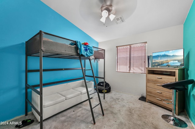 unfurnished bedroom featuring lofted ceiling, light carpet, and ceiling fan