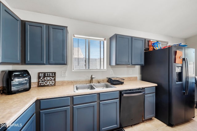 kitchen with light tile patterned floors, stainless steel appliances, sink, and blue cabinets