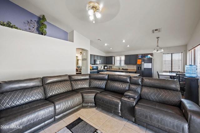 living room with sink, light tile patterned flooring, ceiling fan with notable chandelier, and a healthy amount of sunlight