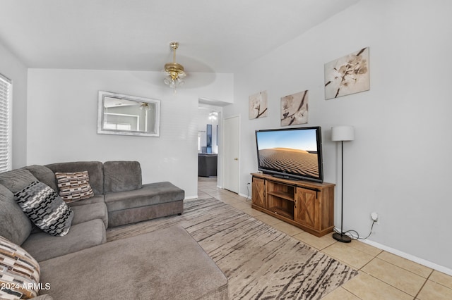 living room featuring lofted ceiling, light tile patterned floors, and ceiling fan