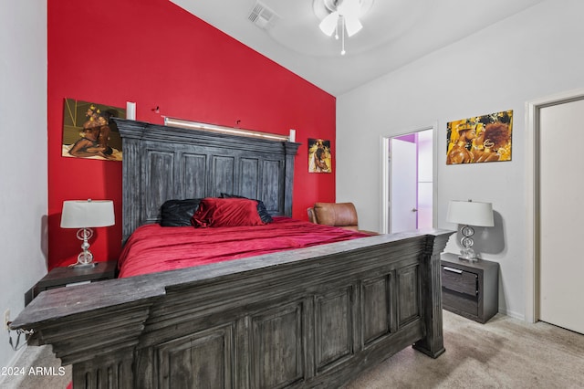 bedroom featuring ceiling fan, lofted ceiling, and light colored carpet