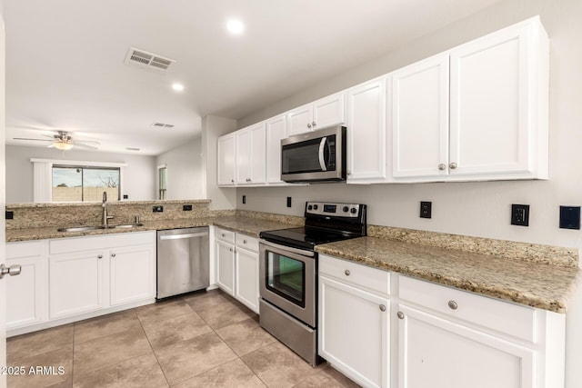 kitchen featuring a sink, visible vents, appliances with stainless steel finishes, and white cabinetry