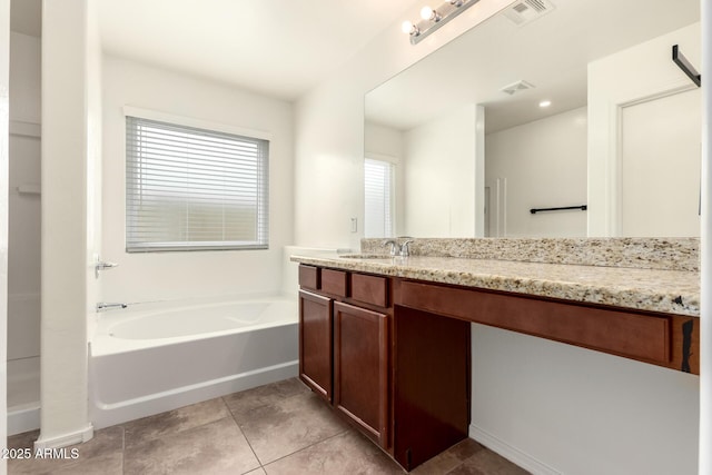 bathroom with visible vents, a bath, vanity, and tile patterned flooring