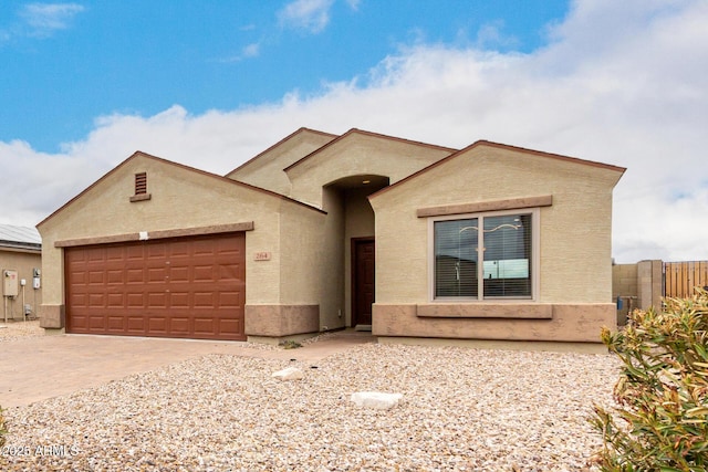 ranch-style house with an attached garage, fence, driveway, and stucco siding