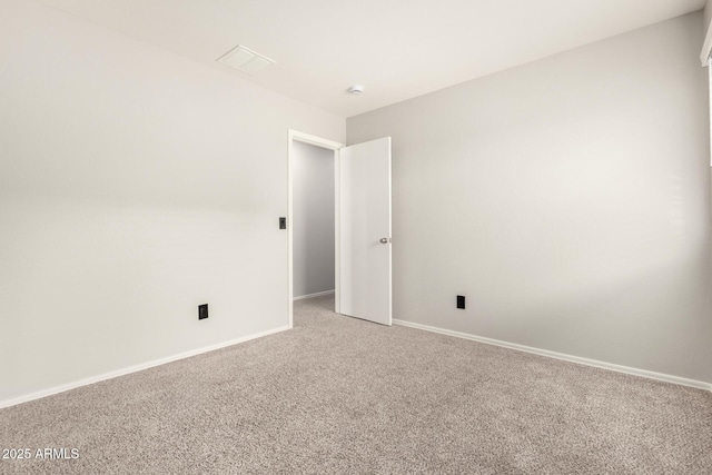 empty room with baseboards and light carpet