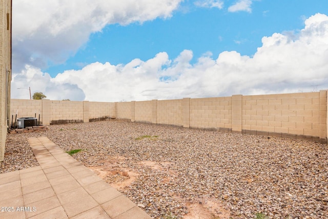 view of yard with cooling unit and a fenced backyard