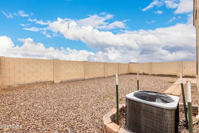 view of yard with central AC unit and a fenced backyard