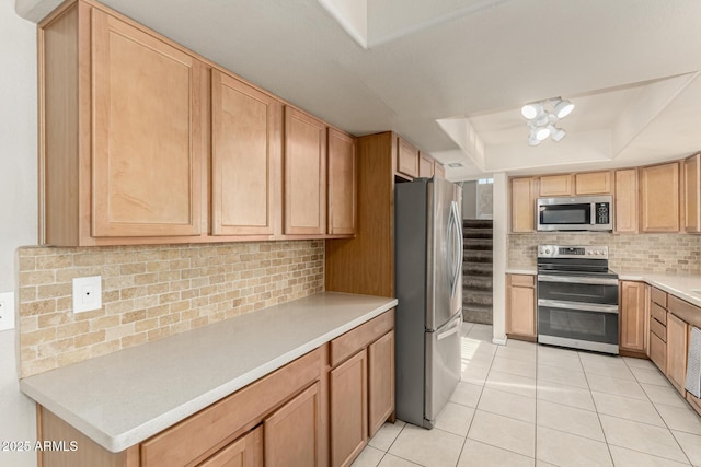 840 N Acacia, Mesa, AZ 85213 - kitchen featuring stainless steel appliances, a tray ceiling, light tile patterned floors, decorative backsplash, and light countertops