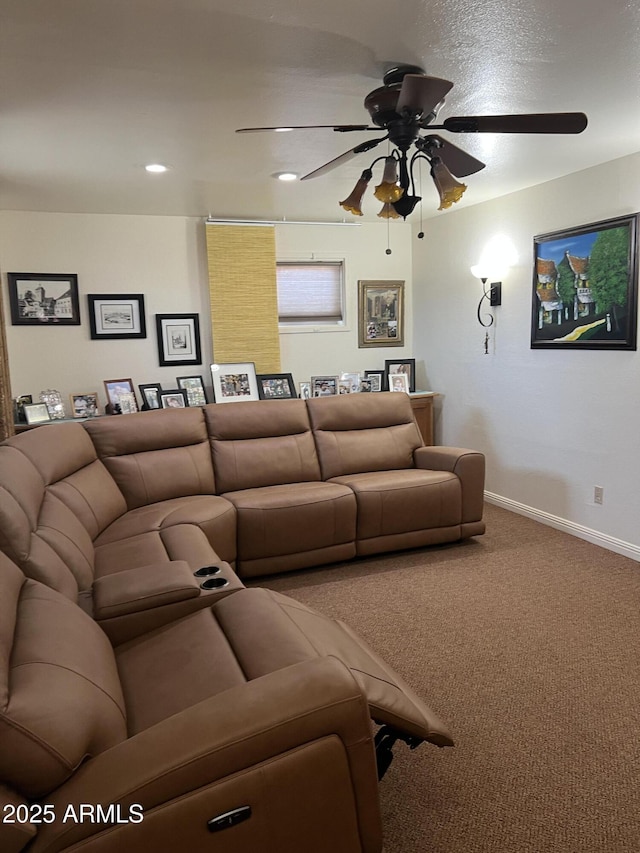 living room featuring carpet floors, baseboards, and a ceiling fan