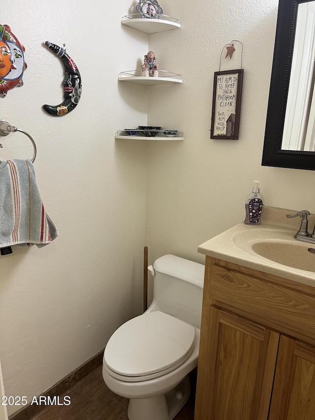 half bath featuring toilet and vanity