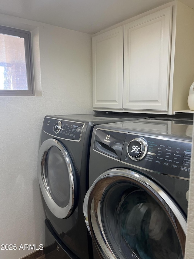 laundry area featuring cabinet space and washing machine and clothes dryer
