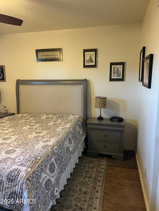 bedroom featuring baseboards and wood finished floors