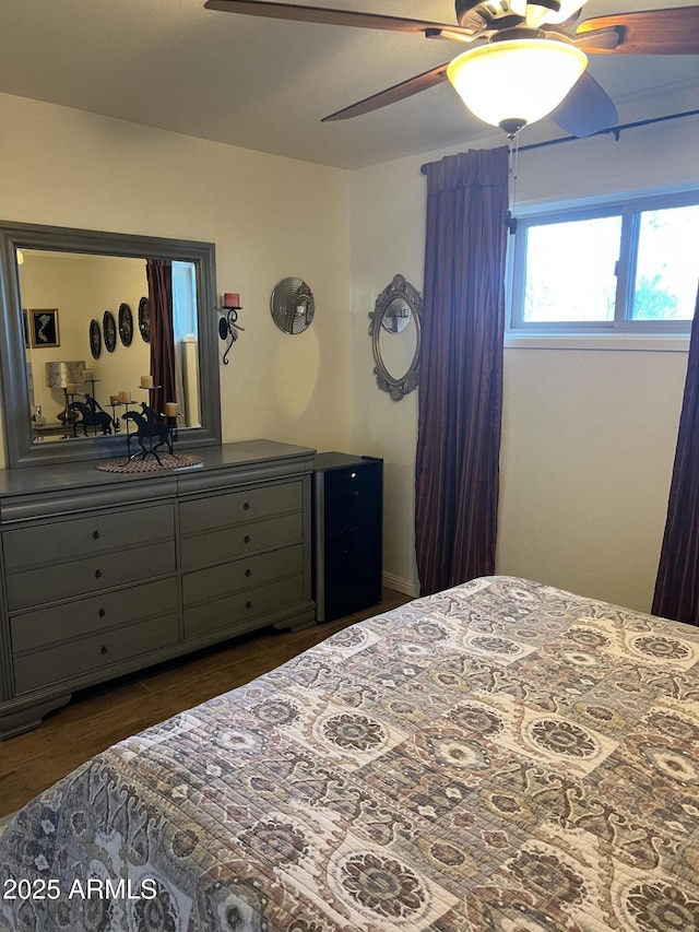 bedroom featuring a ceiling fan and dark wood-style flooring