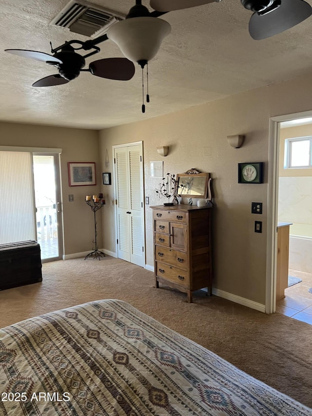 carpeted bedroom with baseboards, a textured ceiling, and visible vents