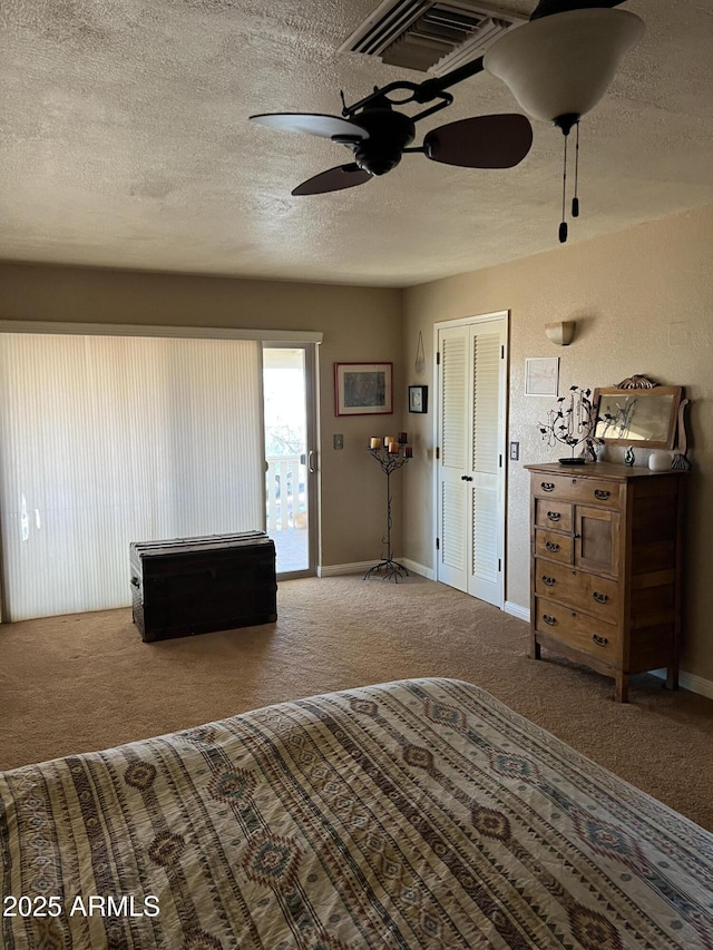 carpeted bedroom featuring visible vents, access to exterior, baseboards, ceiling fan, and a textured ceiling