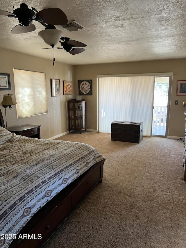 carpeted bedroom featuring access to outside, a textured ceiling, ceiling fan, and baseboards