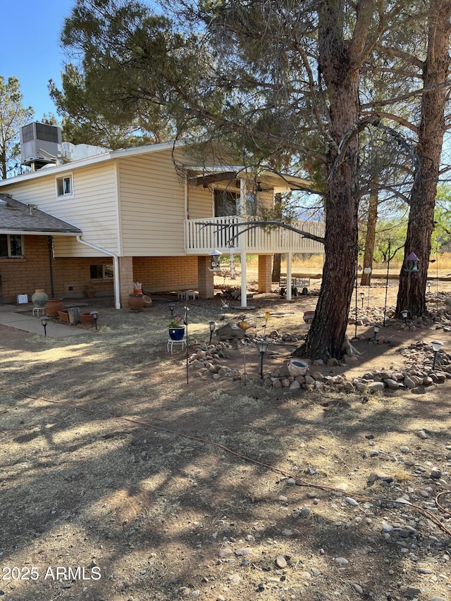 back of property featuring central AC unit