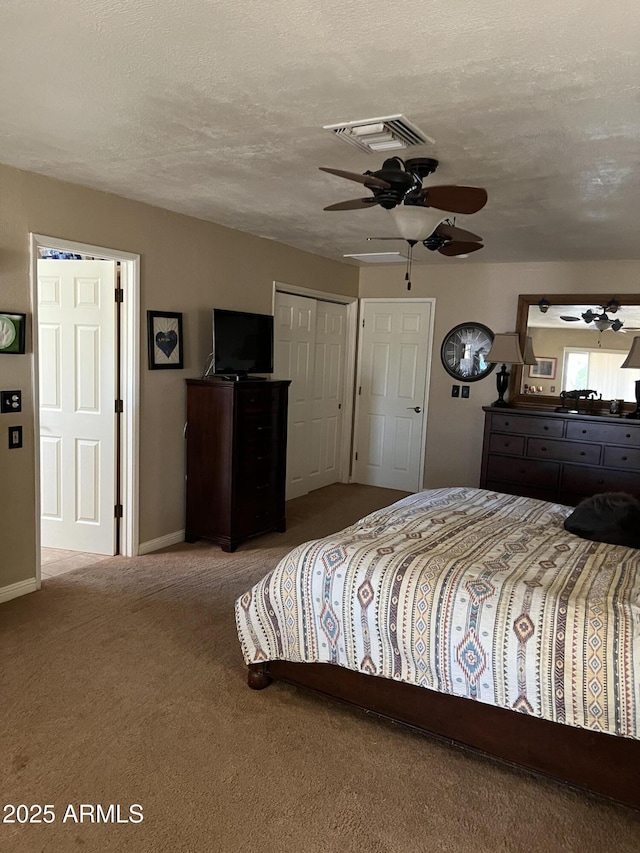 carpeted bedroom featuring a ceiling fan, baseboards, visible vents, and a textured ceiling