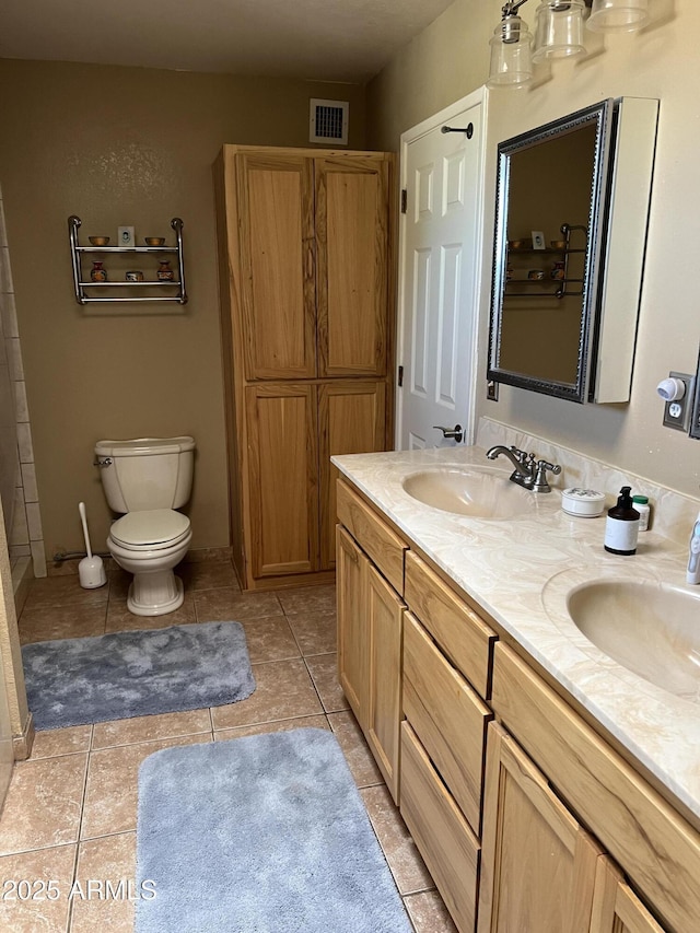 full bath featuring a sink, toilet, double vanity, and visible vents