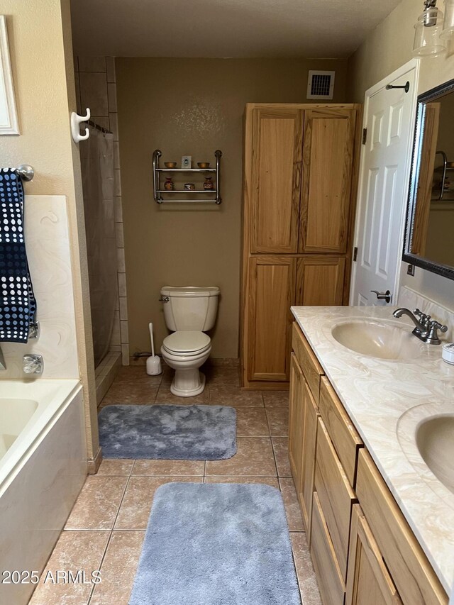 full bathroom with visible vents, toilet, a bath, tile patterned floors, and a sink
