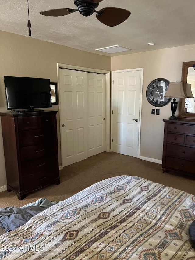 carpeted bedroom with baseboards, ceiling fan, and a closet