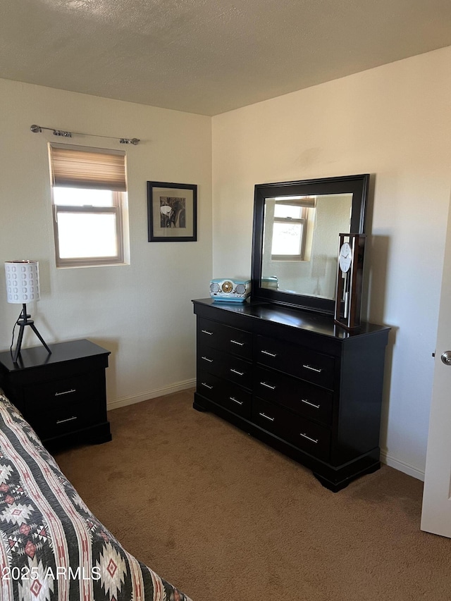 bedroom featuring baseboards, multiple windows, and light colored carpet