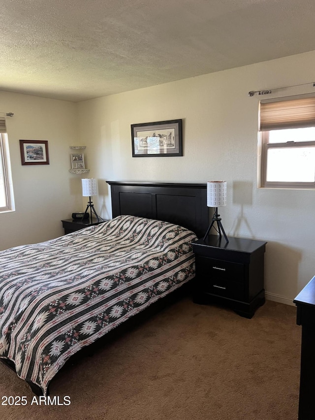 bedroom featuring a textured ceiling and carpet