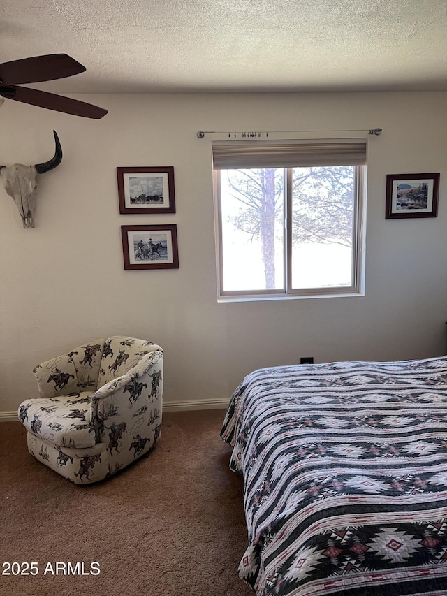 bedroom featuring carpet floors, baseboards, and a textured ceiling