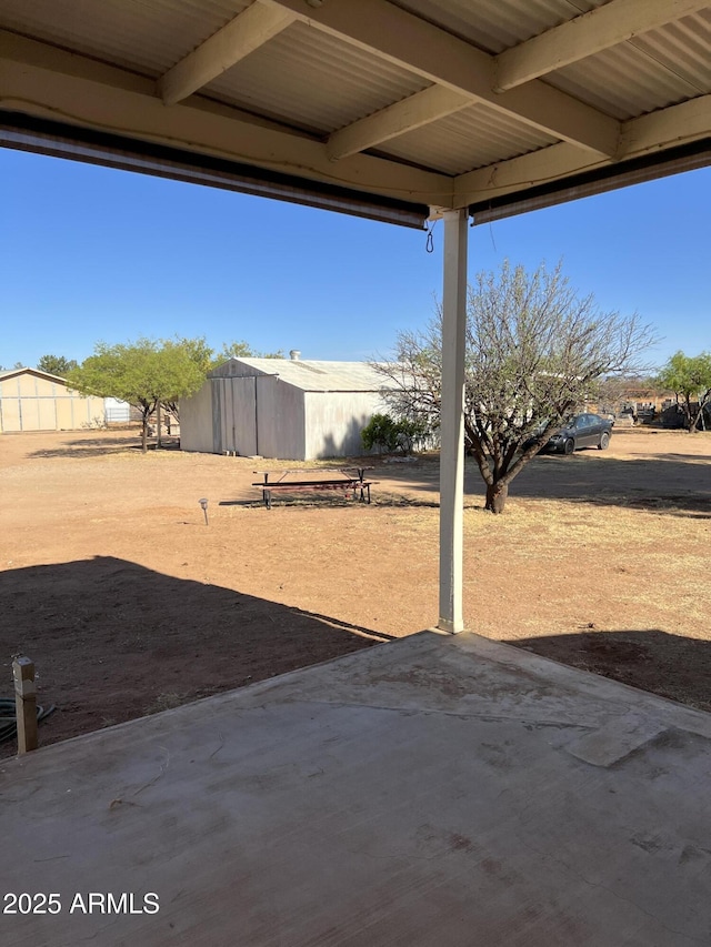 view of yard with a patio and an outbuilding