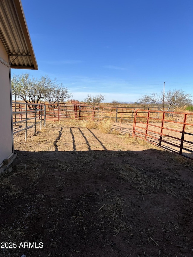 view of yard featuring an exterior structure and a rural view