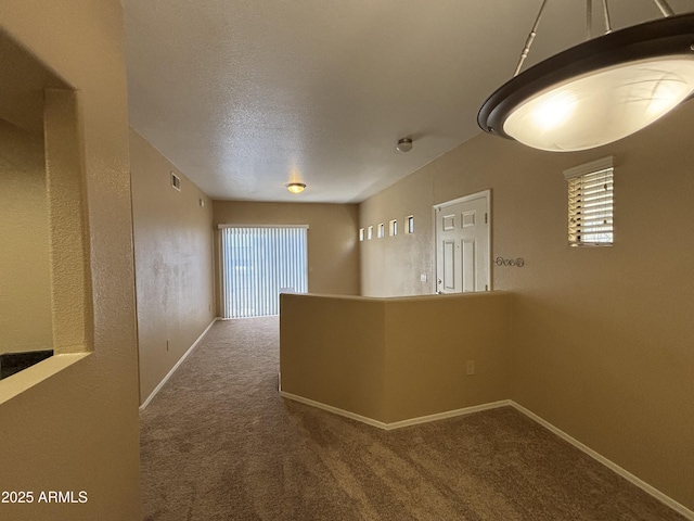 3434 E Baseline Rd Unit 204, Phoenix, AZ 85042 - hallway with carpet and a textured ceiling